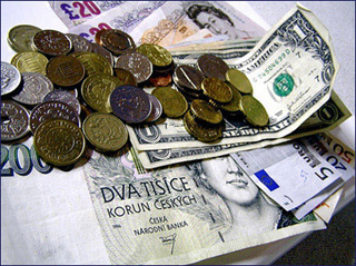 Paper money on a white table, coins strewn on top. Paper money on a white table, coins strewn on top.